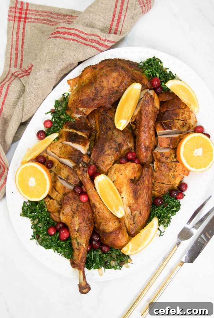 Dry-Brined Spatchcock Turkey: Crispy Skin, Juicy Meat 7 A platter of dry brine turkey sliced with greens and orange slices