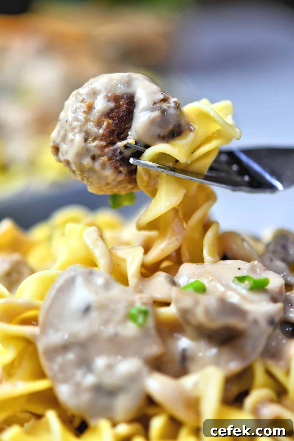 Creamy Meatball Stroganoff with Frozen Meatballs 11 closeup of fork with a meatball and a little pasta
