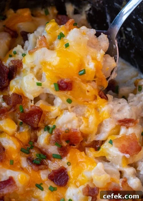 Creamy Cheddar Slow Cooker Potatoes 9 Bacon-topped cheesy potatoes on a spoon