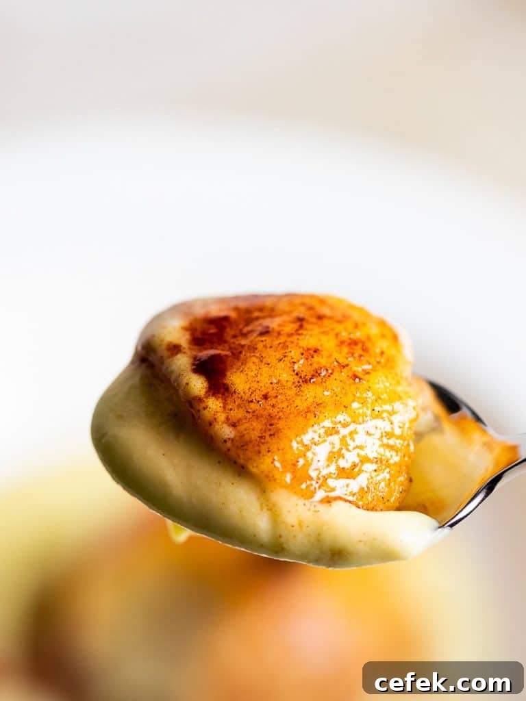 Oven-Baked Cinnamon Apples Recipe 11 baked cinnamon apple with vanilla sauce on a spoon