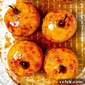 whole baked cinnamon apples in a baking dish