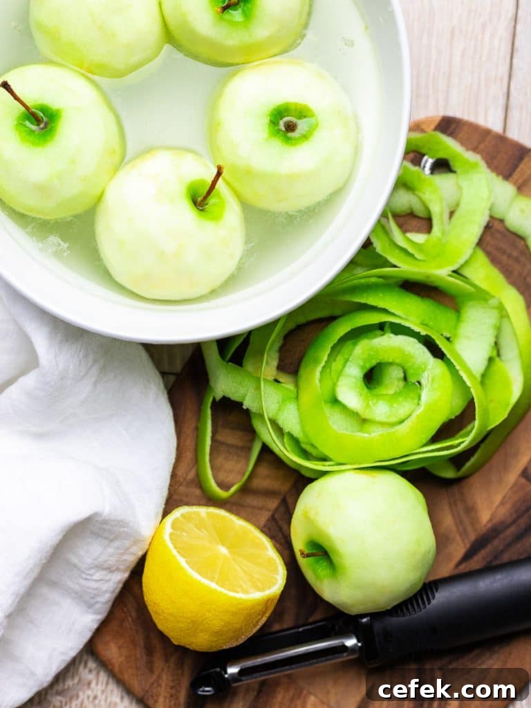 Oven-Baked Cinnamon Apples Recipe 6 peeled apples in a bowl of water with lemon
