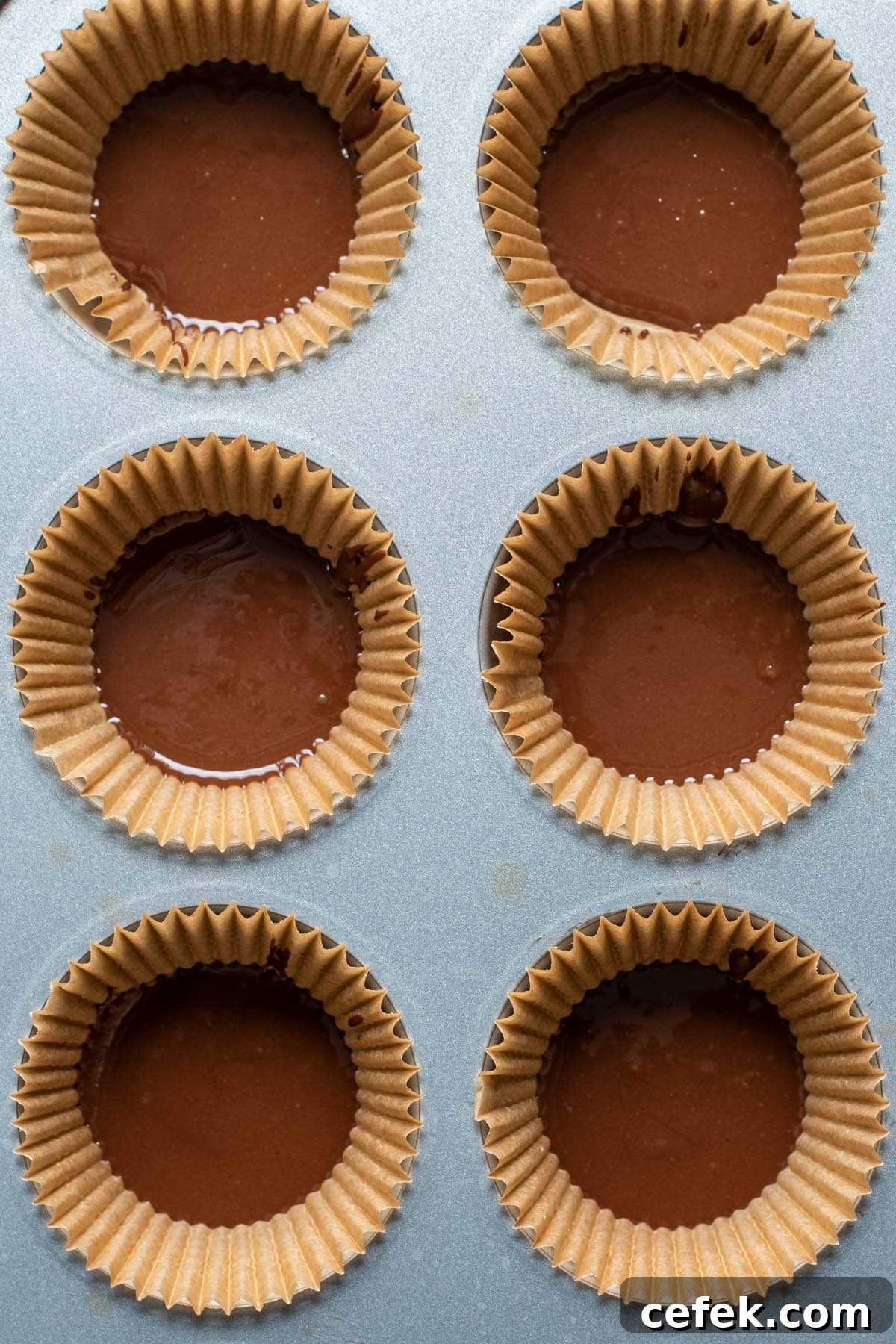 No-Bake 2-Ingredient Peanut Butter Cups 5 Melted chocolate in a muffin tin cup.