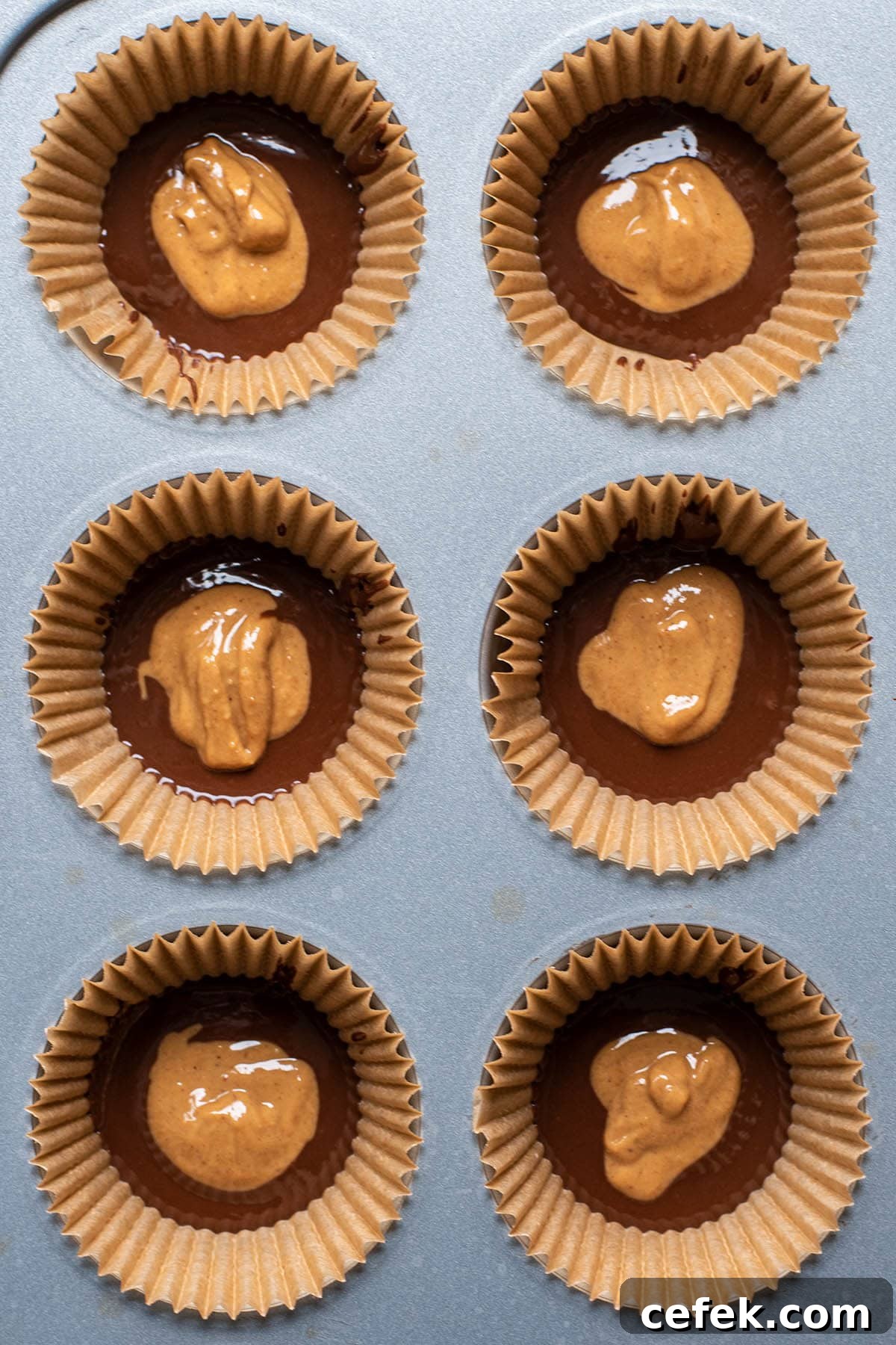 No-Bake 2-Ingredient Peanut Butter Cups 6 Layered chocolate and natural creamy peanut butter in muffin tin.