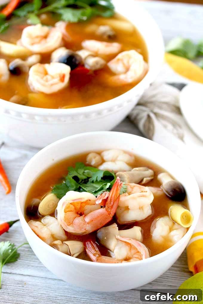 Authentic Thai Tom Yum Soup with Shrimp 2 Tom Yum soup with shrimp on a white bowl