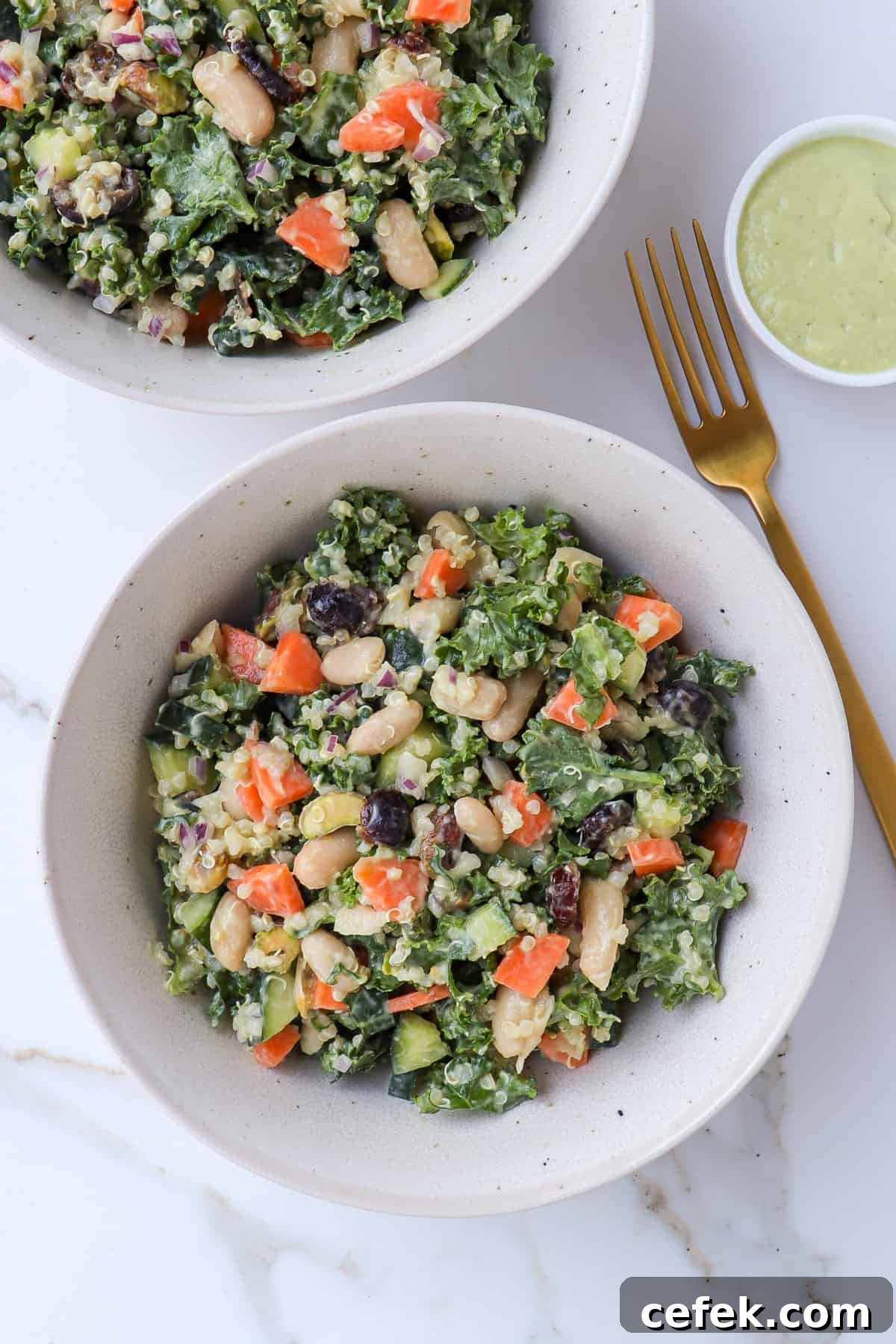 White Bean and Kale Salad with Creamy Avocado Dressing 8 Kale and white bean salad served in bowls.