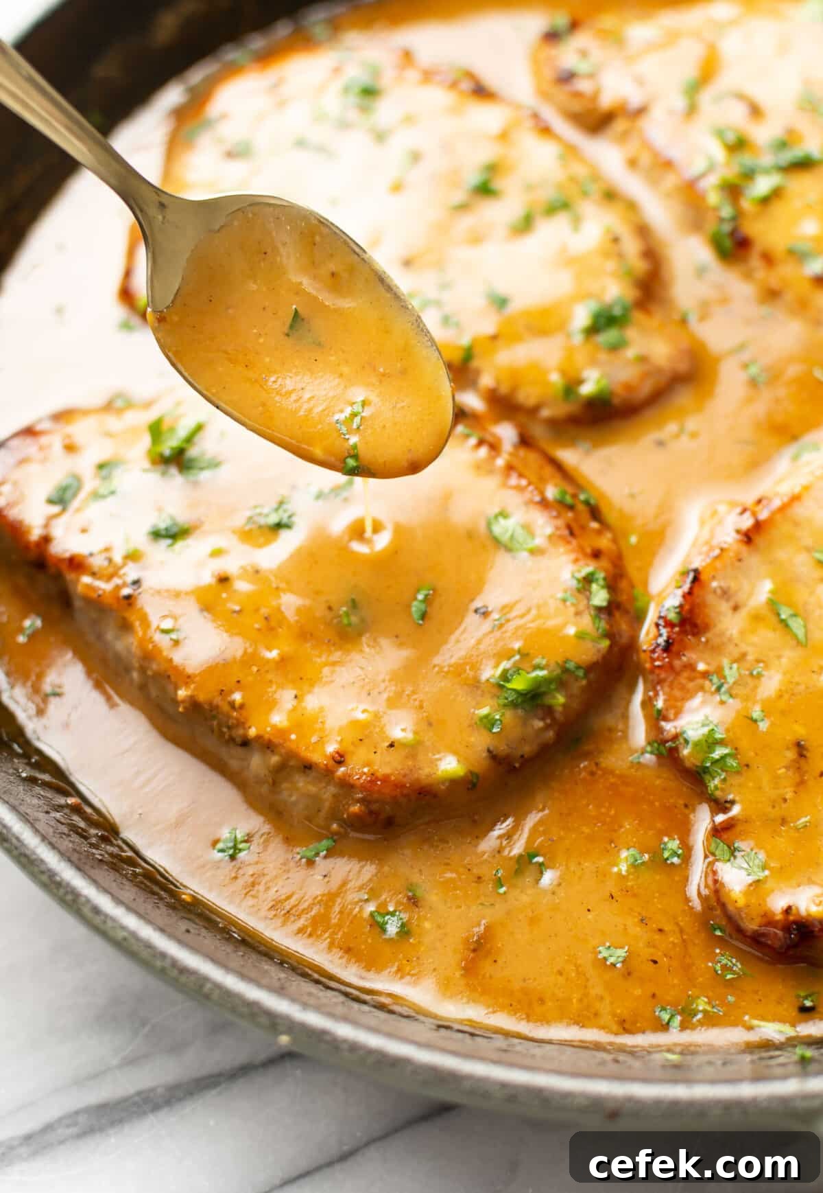 Honey Mustard-Glazed Pork Chops 6 a skillet with honey mustard pork chops and a serving spoon