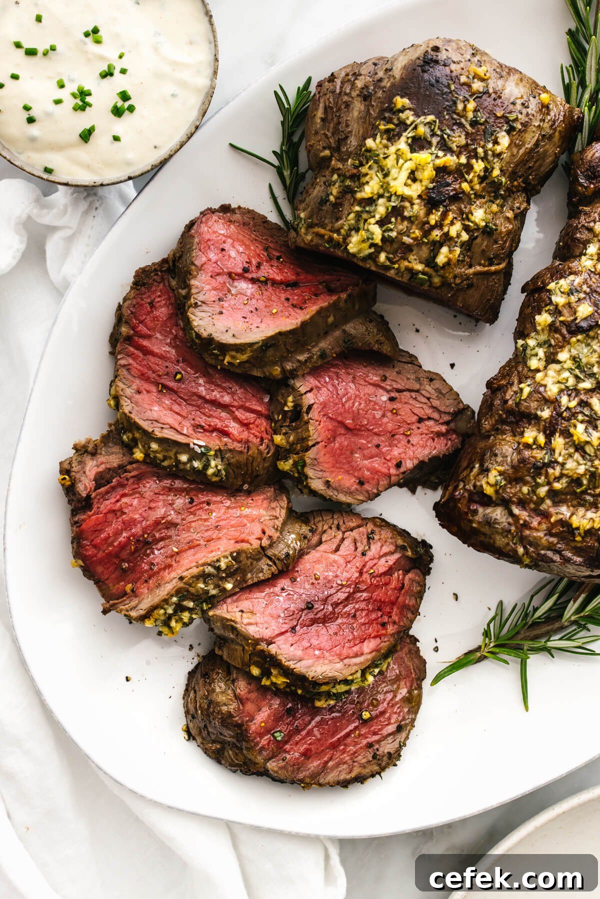 Gluten-Free Thanksgiving Menu: Recipes for a Festive Feast 7 Slices of beef tenderloin on a plate.