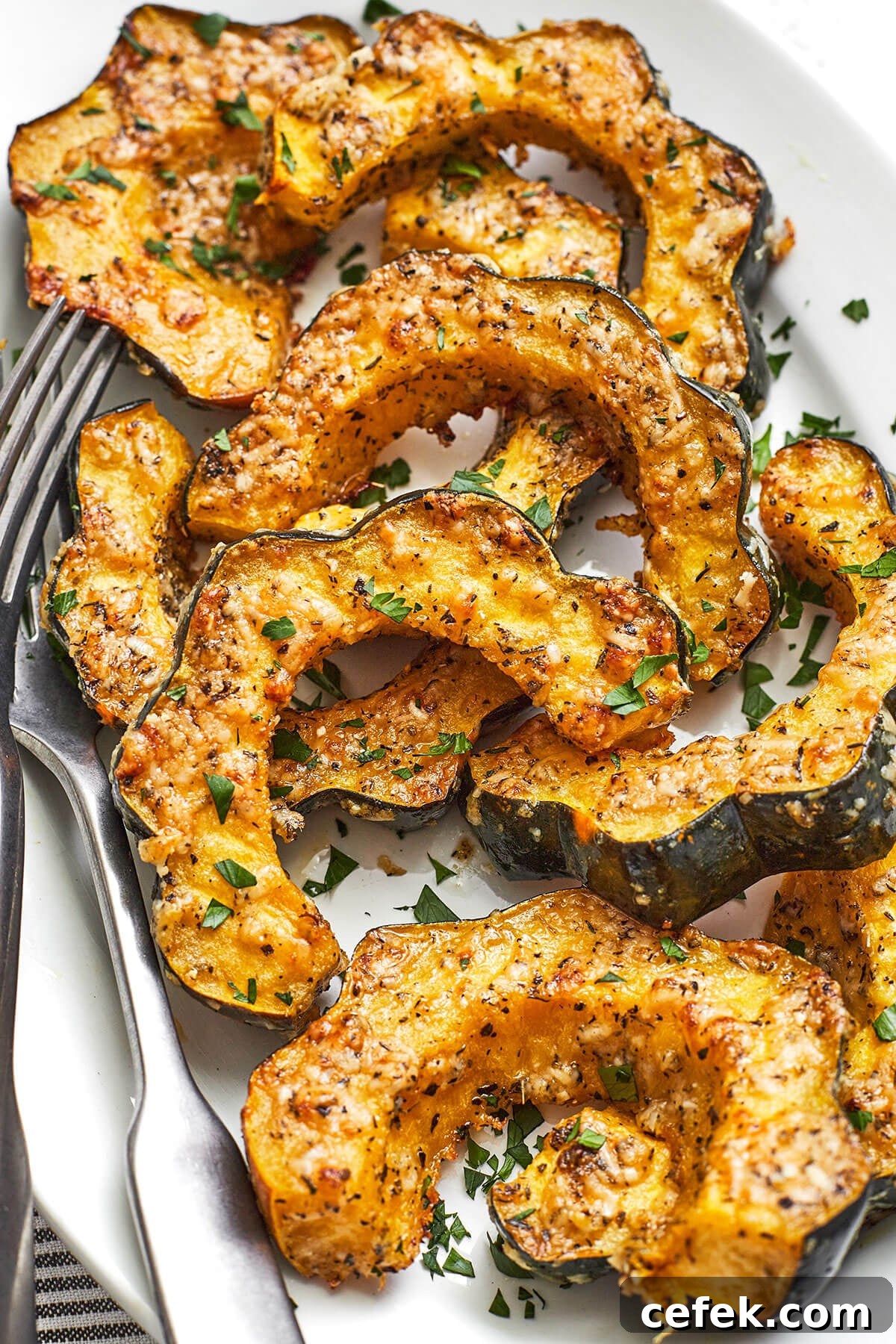 Gluten-Free Thanksgiving Menu: Recipes for a Festive Feast 10 Parmesan herb roasted acorn squash on a platter with a fork